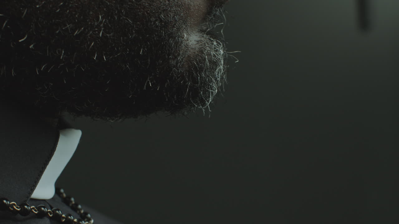 Close-Up of Pastor Holding Bible and Reading Prayer in Church