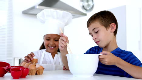 siblings preparing pastry together