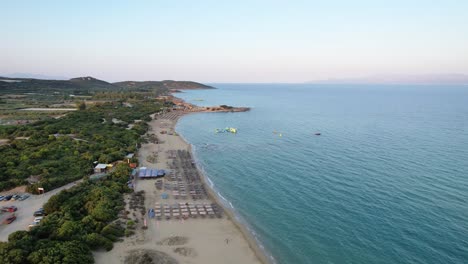 ammolofoi beach in kavala greece, aerial panoramic view of beach bars and blue waters, dawn lighting, point of interest shot