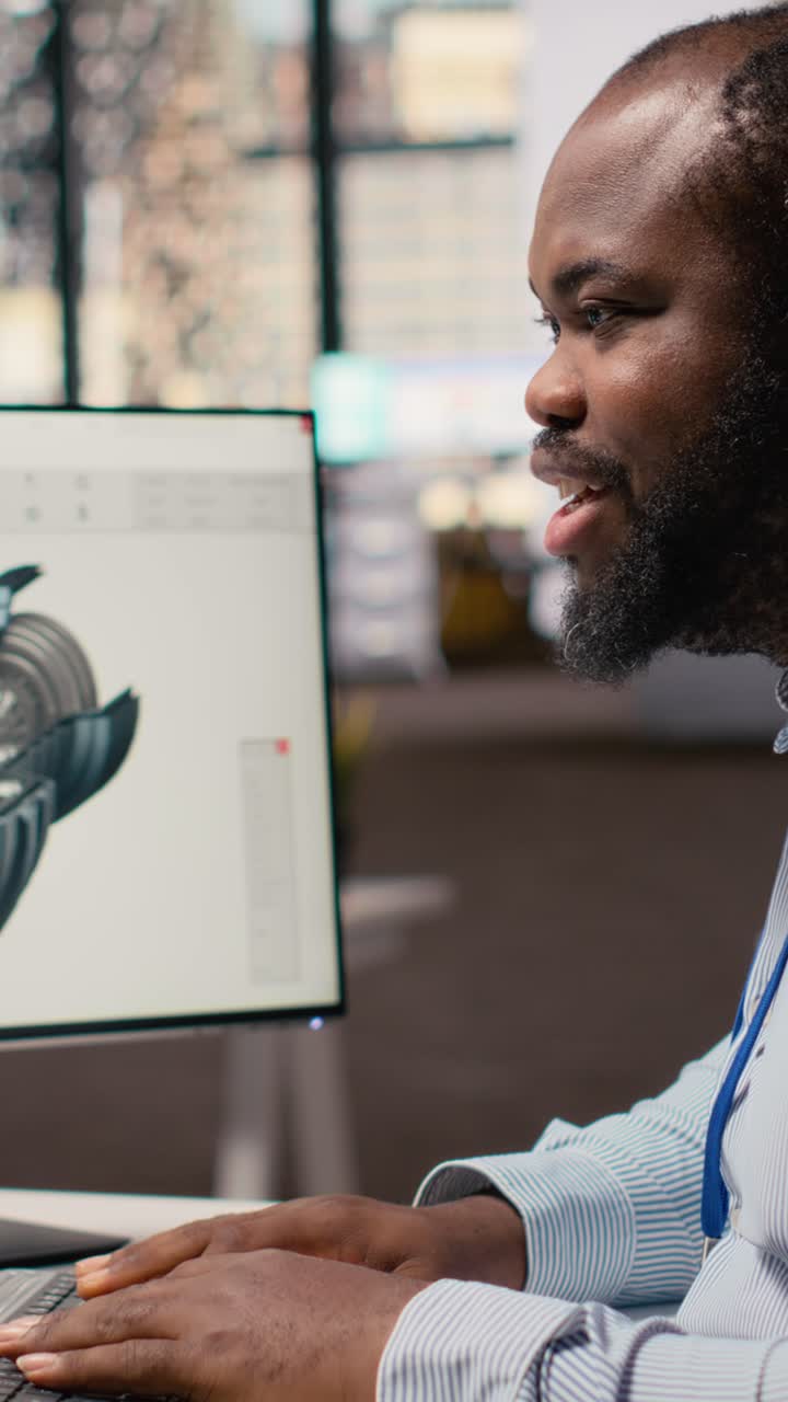 Engineer in office working on wind turbine CAD design for improved technology