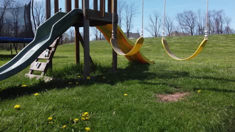 kids swingset in green grass