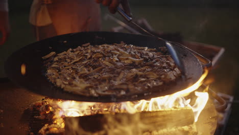 cooking mushrooms over a campfire