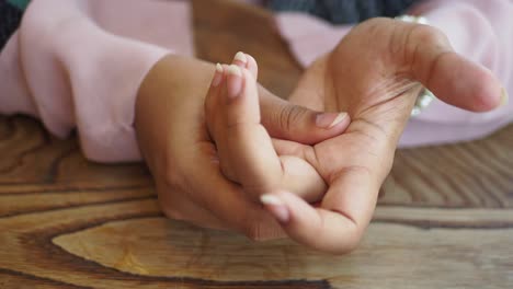 hands resting on a wooden table