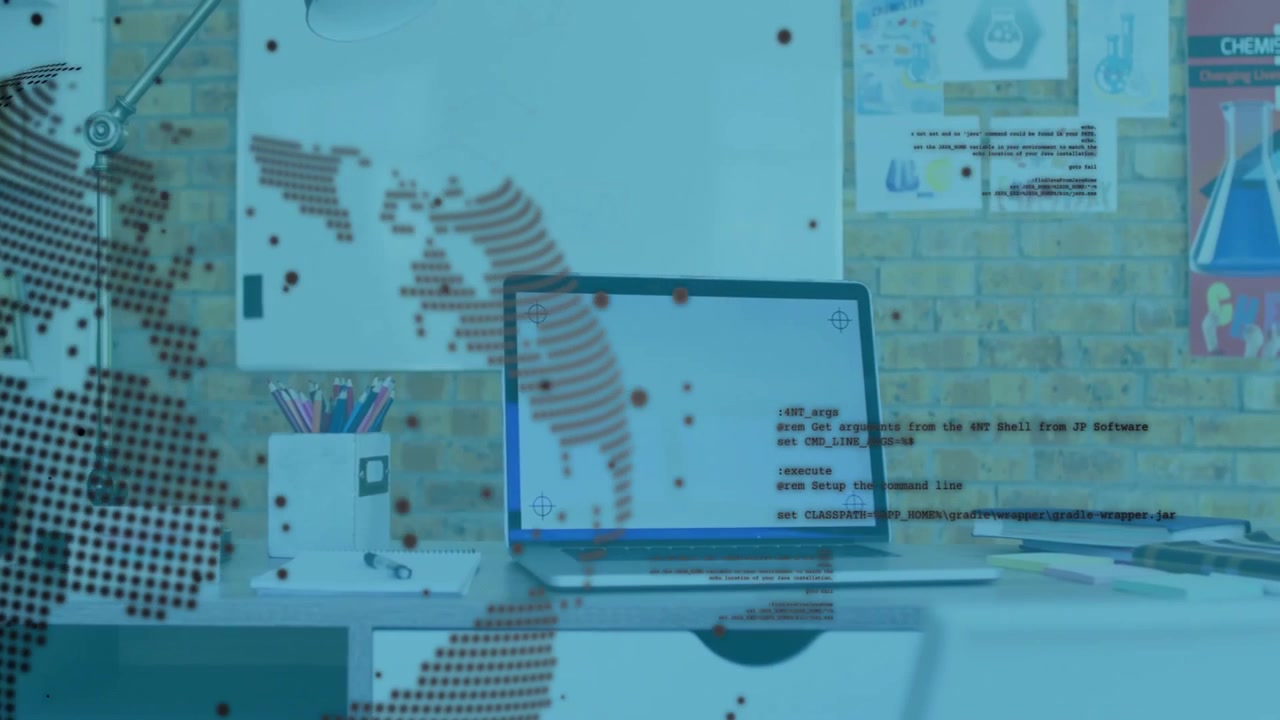Laptop on desk with digital world map and coding animation overlay