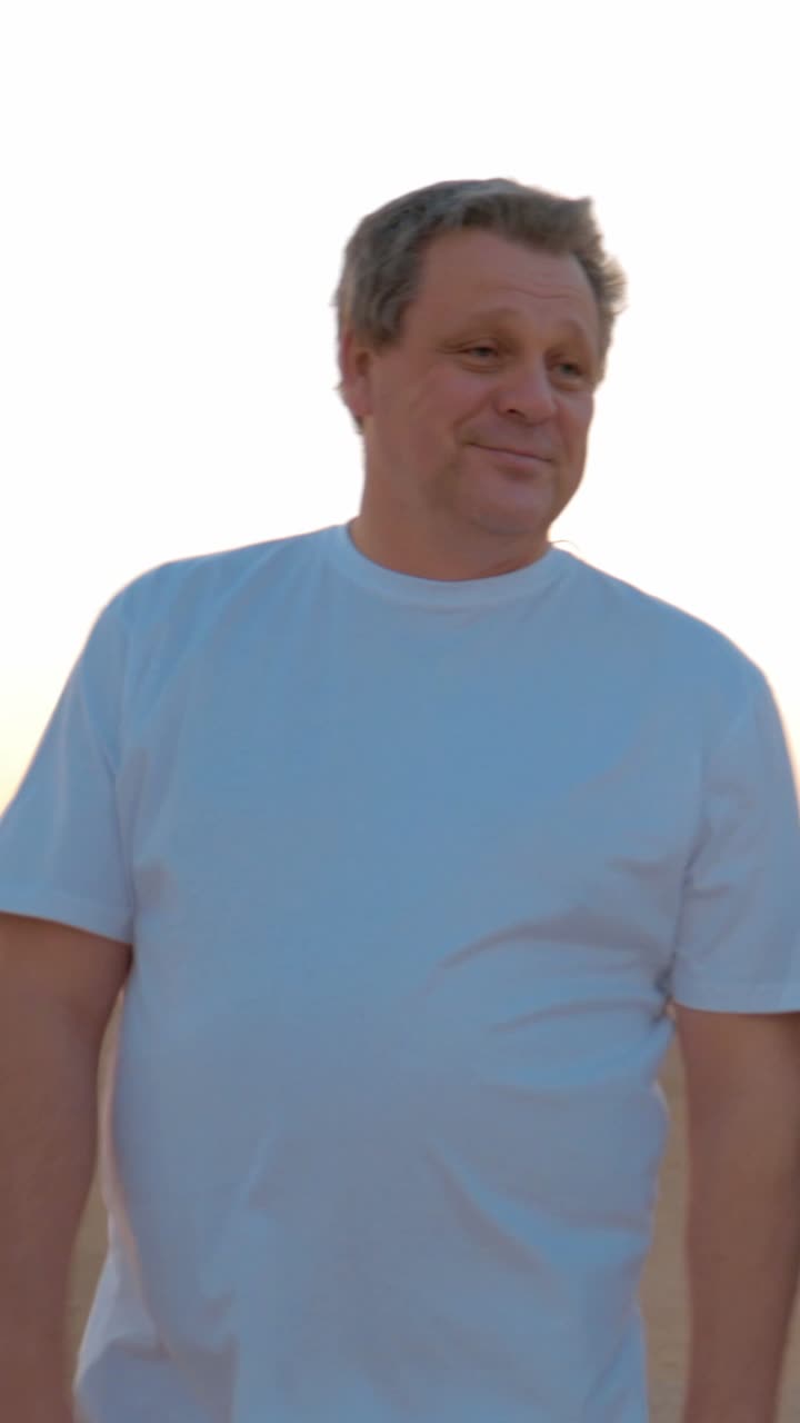 A man in a T-shirt on a beach