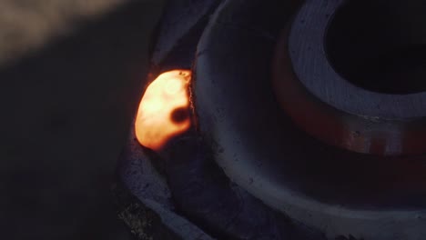 red hot piece of metal after welding with electrode - close shot slow motion