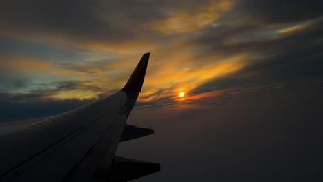 view from plane window with dynamic sunset during flight