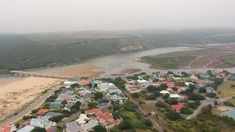 Aerial-Pan-shot-of-tropical-lagoon-draining-into-ocean