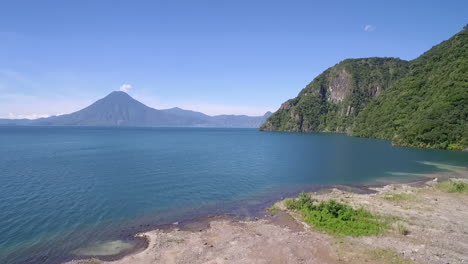 aerial over lake amatitlan in guatemala reveals the pacaya volcano in the distance 4