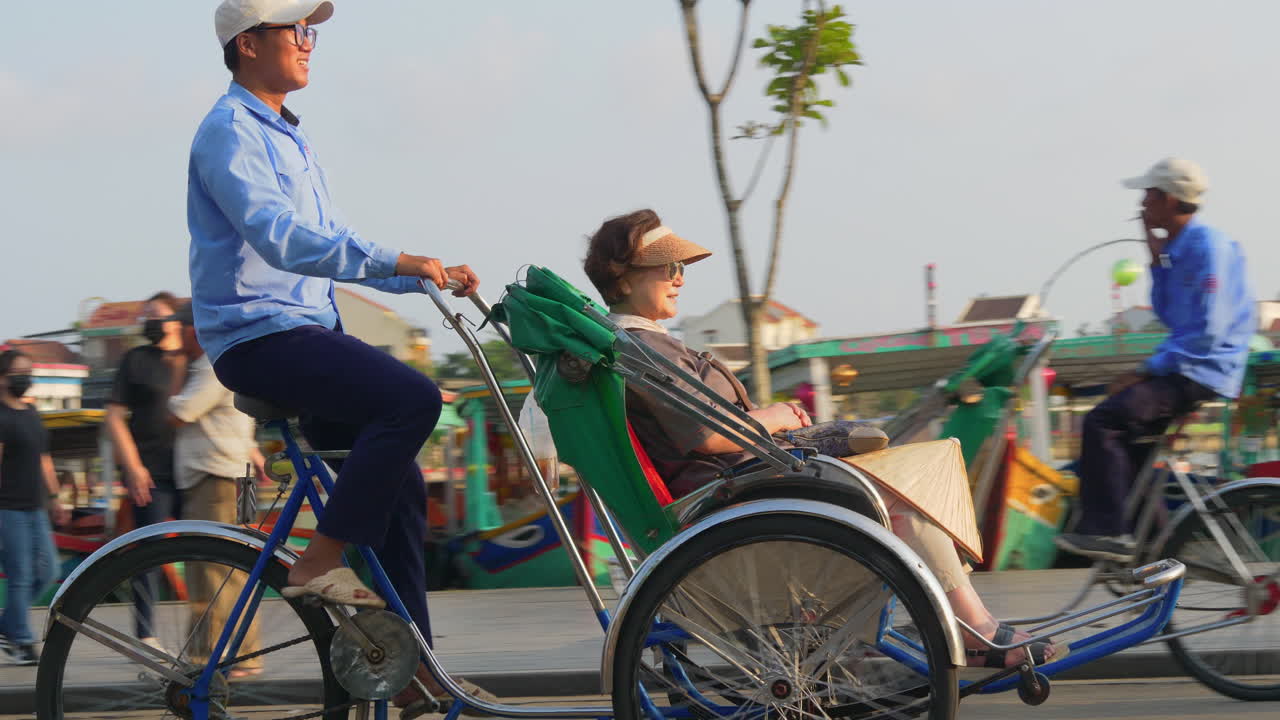 A tracking footage of a tourist on a cyclo rental transpo driving around the city of Hoi An in Vietnam.