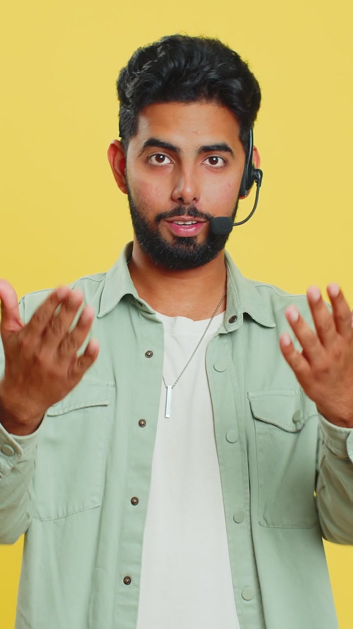 Indian man freelance worker in headset call center support service operator helpline having talk
