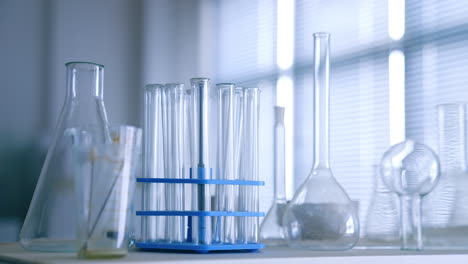 set of test tubes and beakers on the table. empty glassware in the medical laboratory. close up.