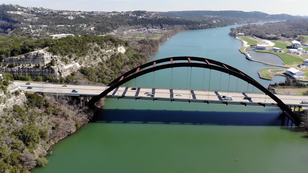 Aerial Austin Pennybacker Bridge - descending towards the bridge up to where the bridge nearly fills the edges of the frame, bridge offset to the right.