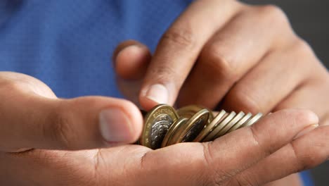 person holding a handful of coins