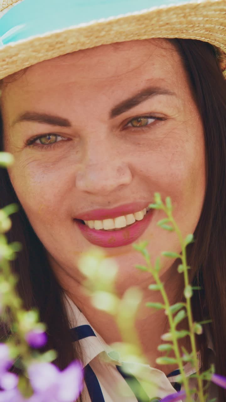 A serene moment captured in nature featuring a woman wearing a straw hat amidst beautiful vibrant flowers, embodying tranquility and joy in a colorful garden setting