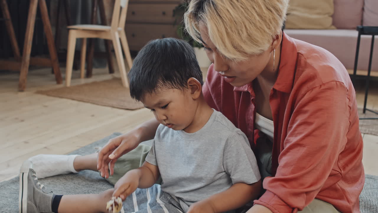 Asian Boy Playing Glucophone with Mom