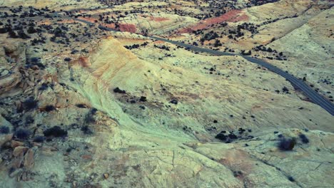 drone view of asphalt road going through sandy valley in utah