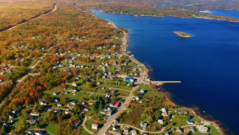 aerial drone shot over the coastline of oak island, nova scotia, canada.
high view of the sea, autumn colorful trees foliage. picturesque landscape. fall vibrant colors.