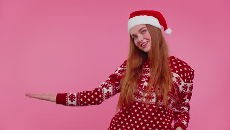 Woman-wears-red-New-Year-sweater-deer-showing-thumbs-up-and-pointing-at-on-blank-advertisement-space