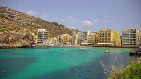 xlendi beach in malta with boats anchored in the bay - time lapse