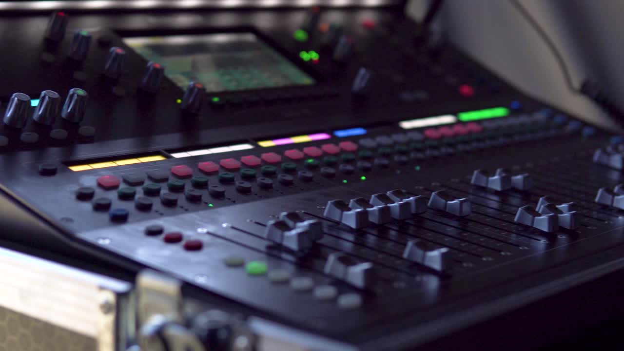 A close-up of a live audio mixer, with precise sound adjustments being made. Perfect for showcasing audio control, mixing process, and the technical side of live production and sound engineering