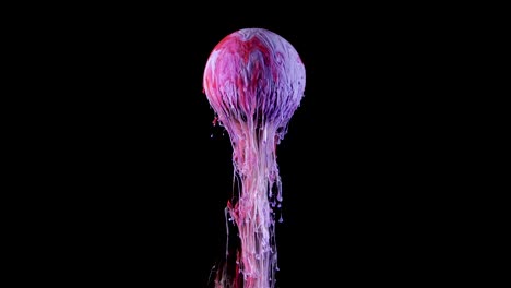 multicolored ink paint slowly flows from the ball