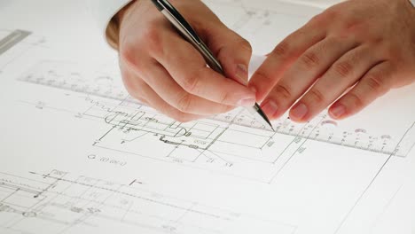 close-up of hands working on a technical drawing