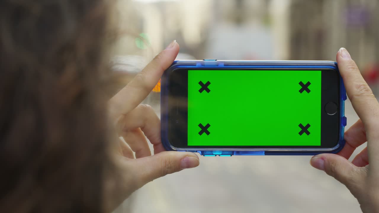 pantalla verde de la llave de croma del teléfono celular con la mano