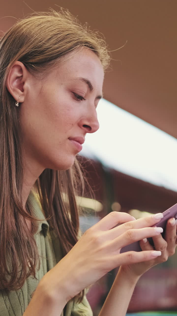 Young Woman Texting and Browsing on Smartphone Outdoors