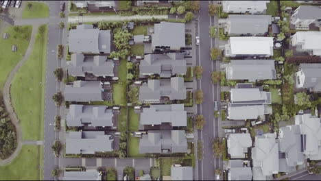 aerial drone flying top down over housing in hobsonville point in auckland, new zealand