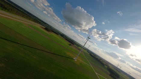 wind turbine farm on sunny day, aerial fpv view