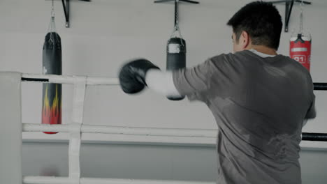 man boxing training session in ring