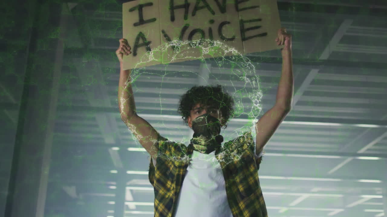 Tech activist man holding sign in industrial space, showcasing green digital energy ring effect