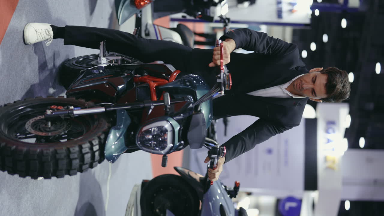 Businessman inspecting a green electric motorcycle at a trade show
