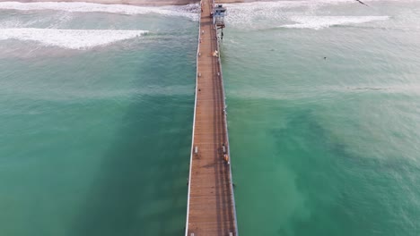 aerial view of southern california pier with a beautful orange sunset