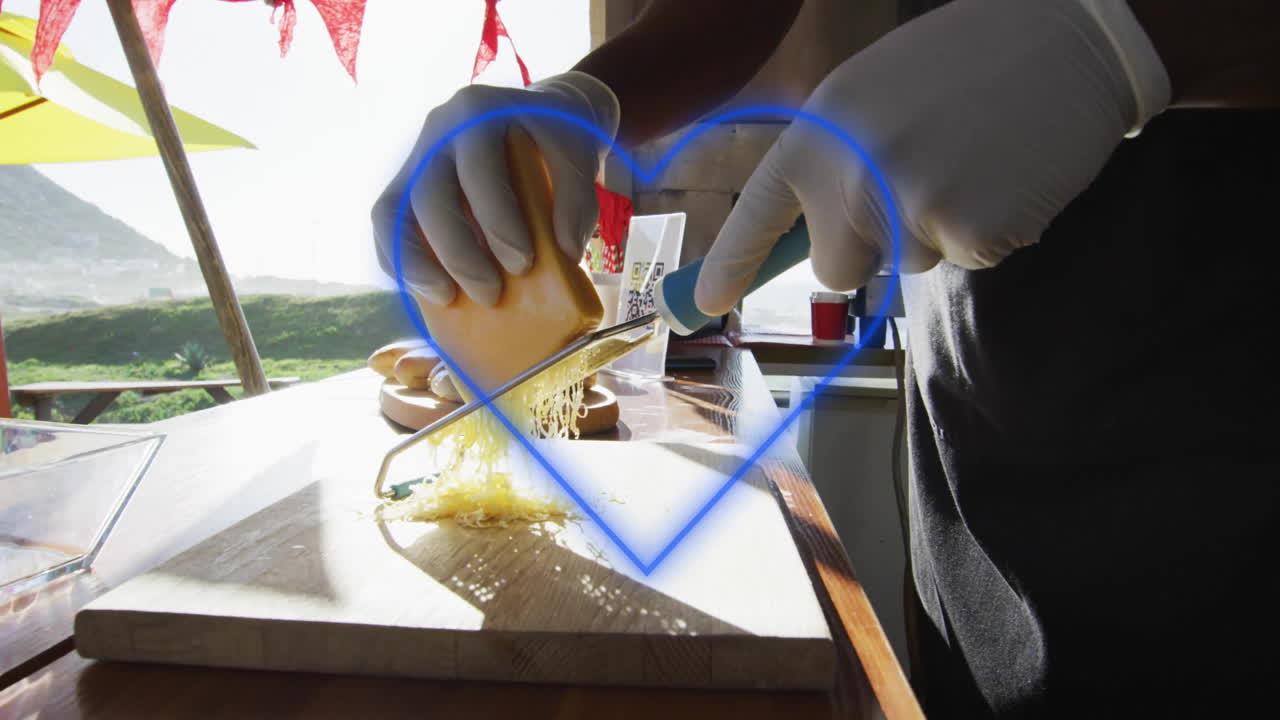 Grating cheese on wooden board, glowing heart animation over kitchen scene