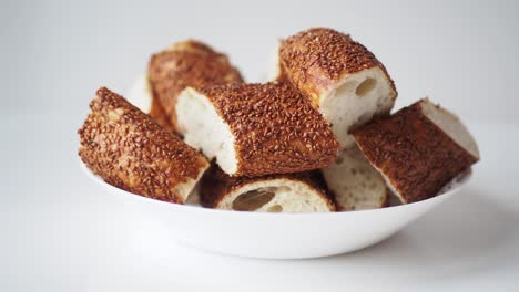 pile of sesame turkish bread (simit) in a white bowl