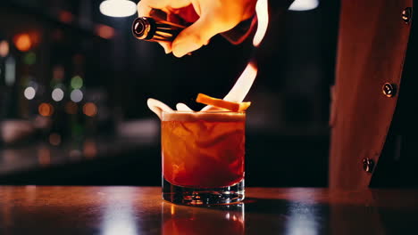 flaming cocktail preparation at a bar