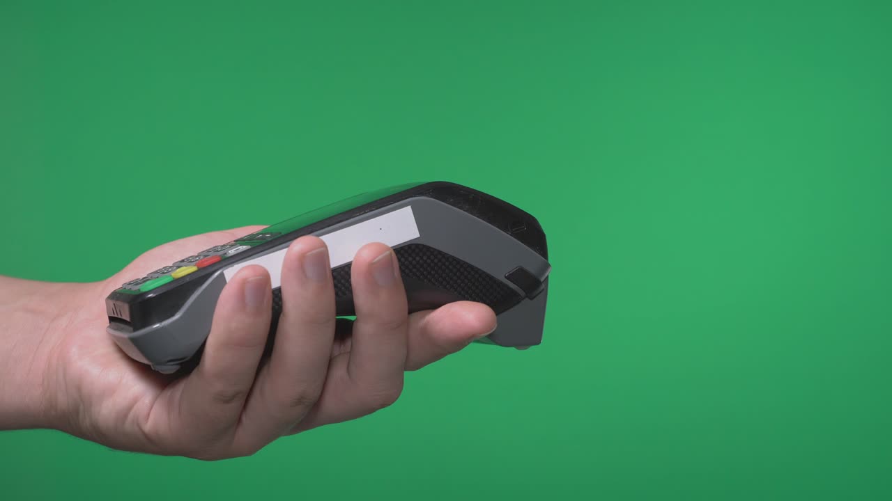 Close up male hold in hand wireless modern bank payment terminal to process acquire credit card payments black card isolated on green screen. Copy space mock up advertising, girl pay
