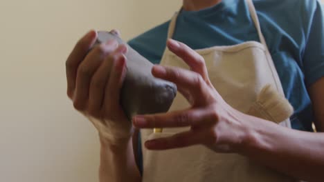 young female potter working in her studio