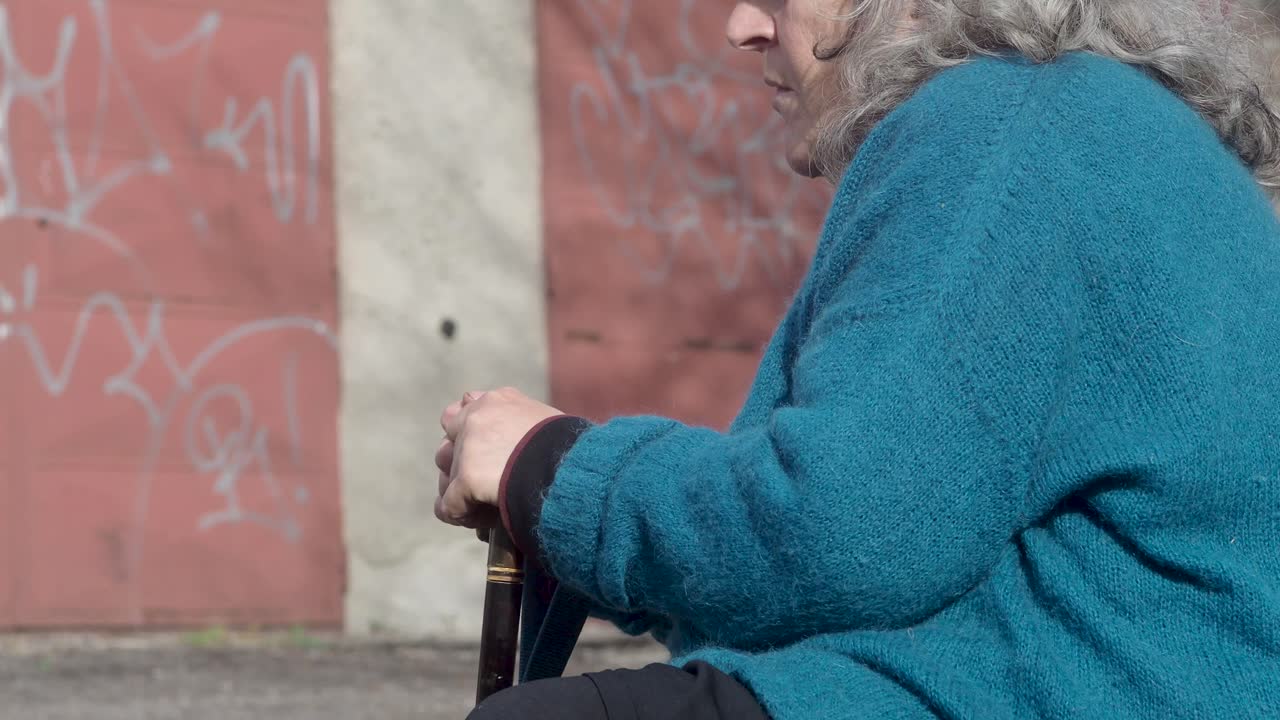 senior woman resting suffering tremor suffering pakinson's desease symptom. Mental health and elderly care concept