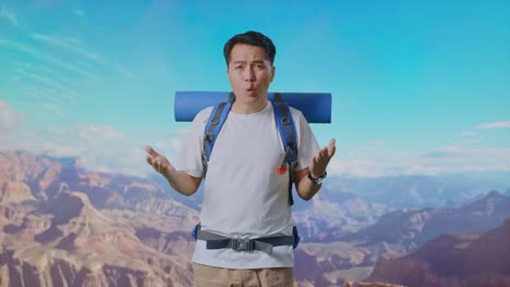 puzzled asian male hiker with mountaineering backpack making gestures doubtfully and saying why while traveling at the top of mountain