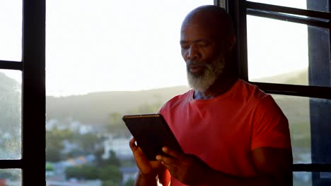 Senior man using digital tablet at home 4k