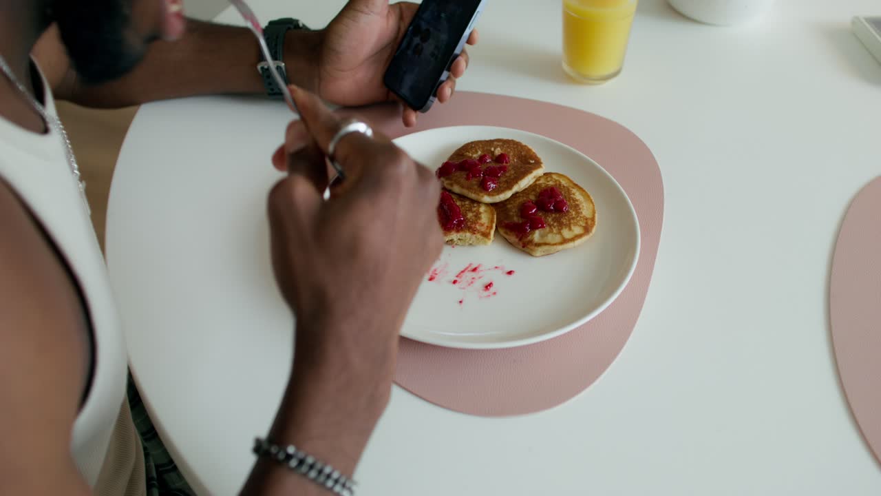 Man Taking a Picture of Pancakes for Social Media