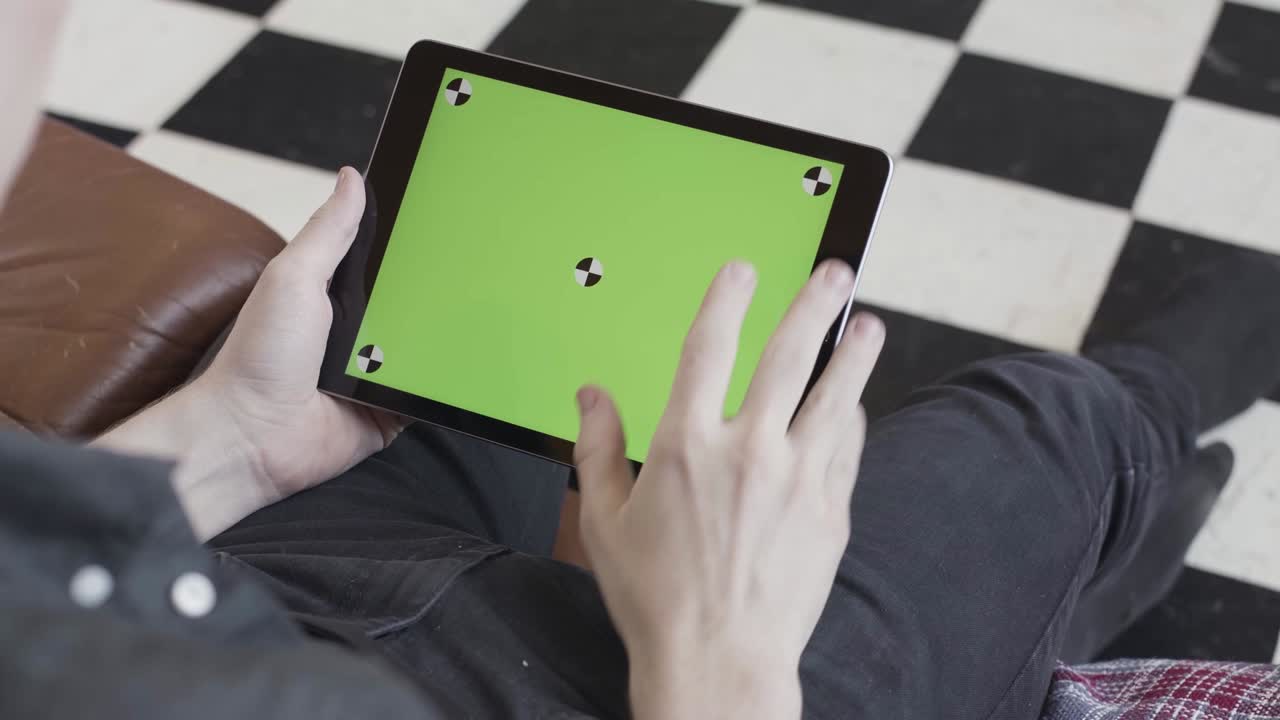 persona que utiliza una tableta con una pantalla verde