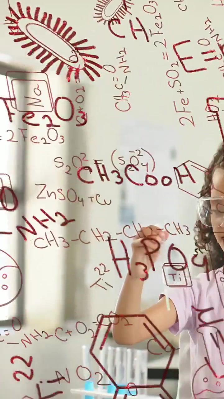 Vertical video: Girl donning goggles drawing blue liquid with pipet doing science with red formulas