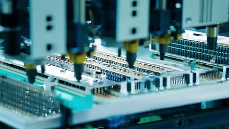 closeup of circuit board being assembled on production line