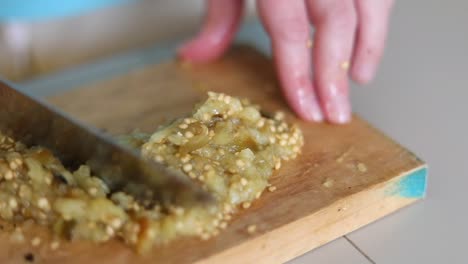 mincing cooked eggplant - close up