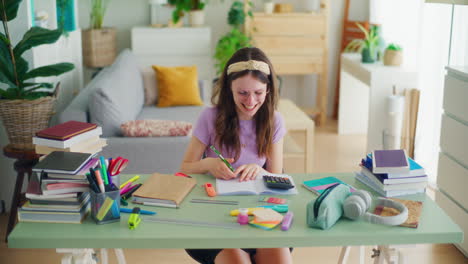 a young student uses a calculator while doing math homework