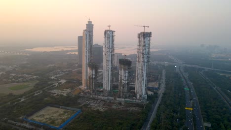aerial drone shot capturing a massive high rise construction site in noida india